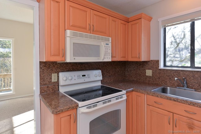 kitchen with decorative backsplash, white appliances, and sink