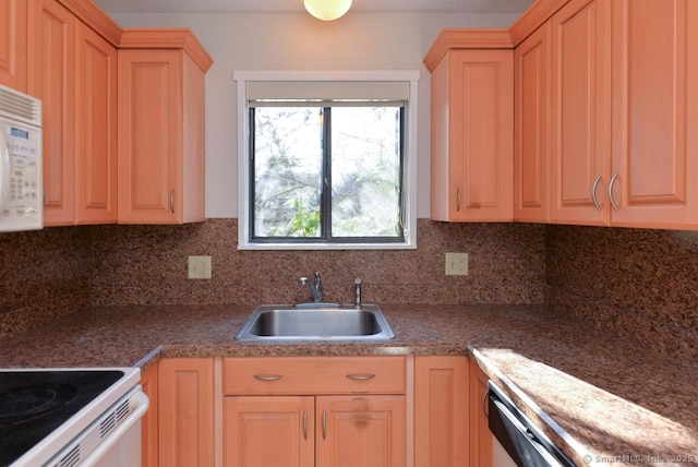 kitchen with decorative backsplash, light brown cabinets, and sink