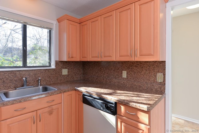 kitchen featuring dishwasher, tasteful backsplash, and sink