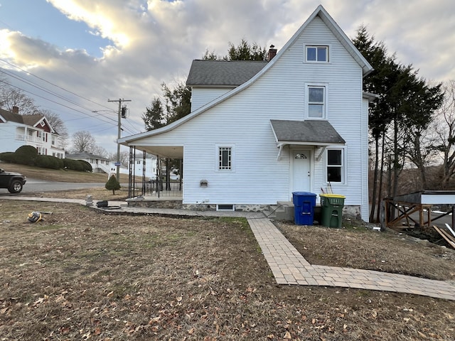 back of property featuring covered porch