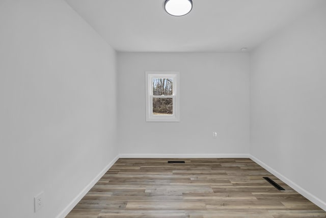 unfurnished room featuring light hardwood / wood-style floors