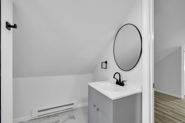 bathroom featuring vanity, lofted ceiling, and baseboard heating