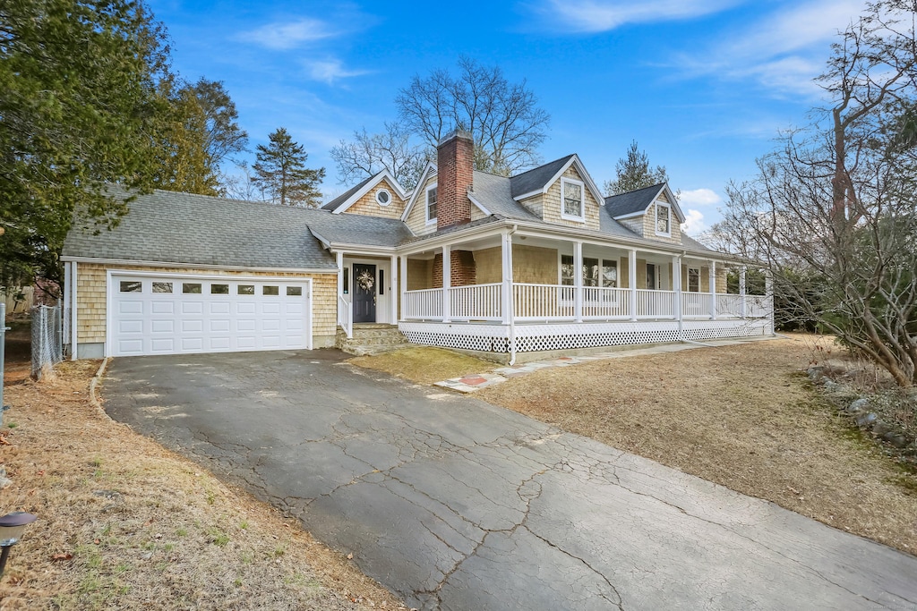 cape cod home with a porch and a garage