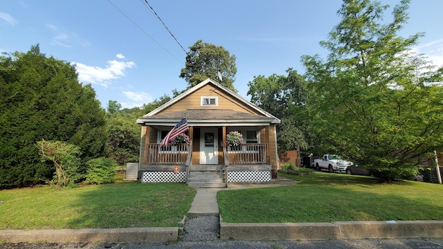 bungalow-style house featuring a front yard and covered porch