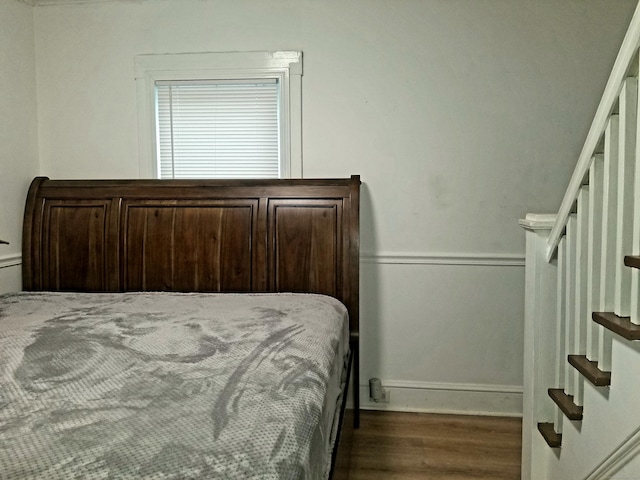 bedroom with dark hardwood / wood-style flooring