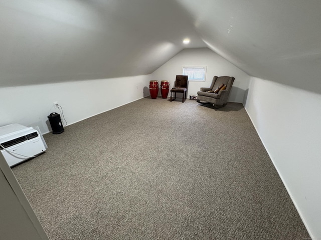 additional living space featuring lofted ceiling and carpet