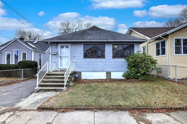 bungalow-style home with a front yard