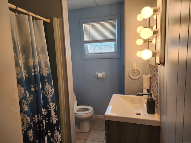 bathroom with curtained shower, tile patterned flooring, vanity, and toilet