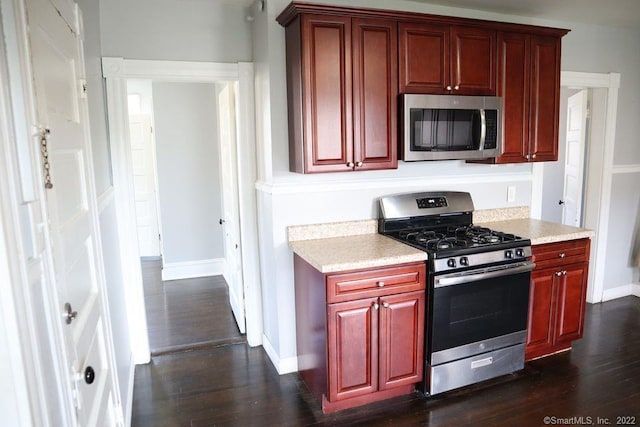 kitchen with dark hardwood / wood-style flooring and stainless steel appliances