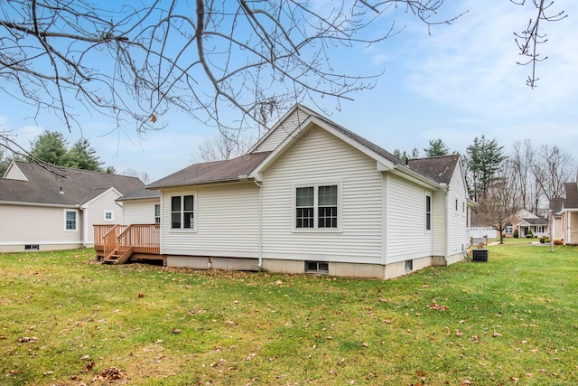 back of property featuring central AC unit, a deck, and a yard