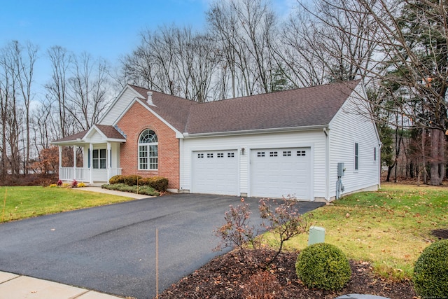 view of front of home featuring a garage, a front lawn, and a porch