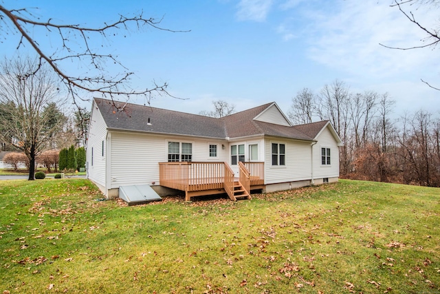 back of house featuring a lawn and a wooden deck