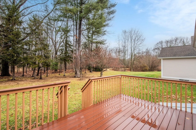 wooden terrace featuring a yard