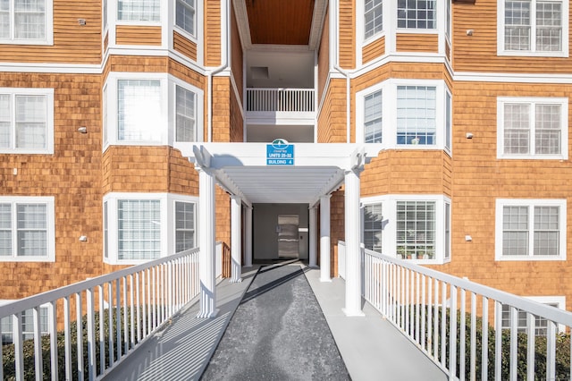 property entrance with a pergola