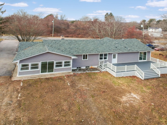 rear view of house with a wooden deck