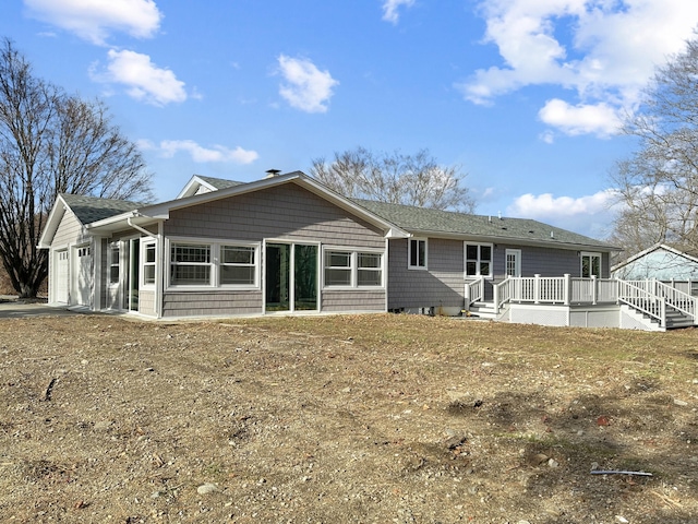 back of house with a garage