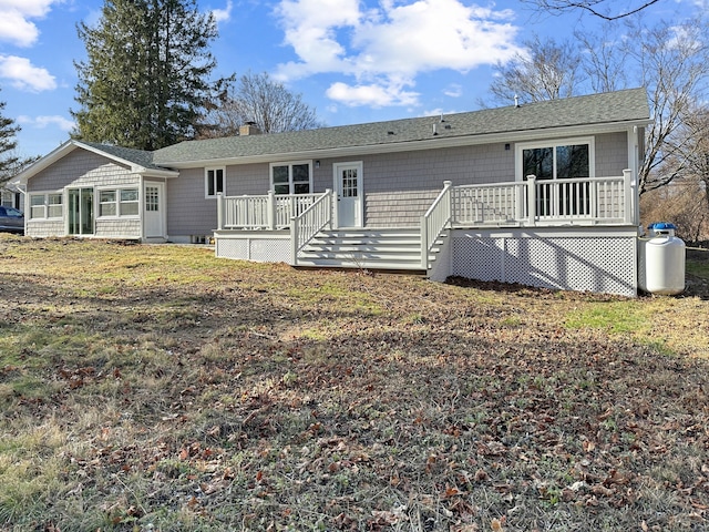 rear view of property featuring a wooden deck