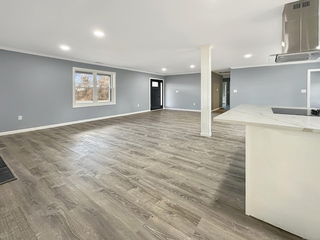 unfurnished living room featuring hardwood / wood-style floors and ornamental molding