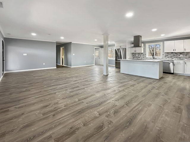 kitchen with white cabinetry, island exhaust hood, a center island, stainless steel appliances, and light hardwood / wood-style flooring