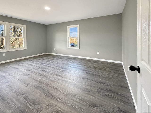 spare room featuring dark hardwood / wood-style flooring