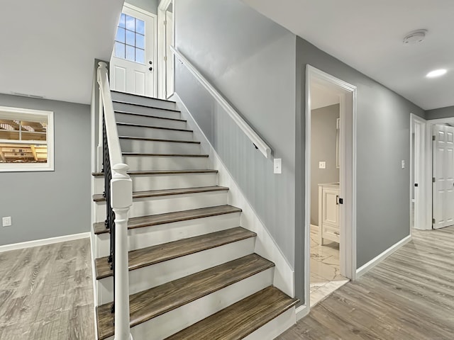 staircase with hardwood / wood-style flooring