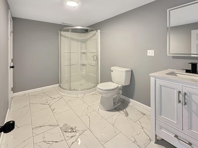 bathroom featuring vanity, toilet, and a shower with shower door