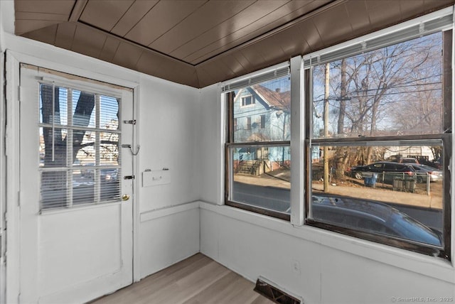 entryway with light hardwood / wood-style flooring and wood ceiling