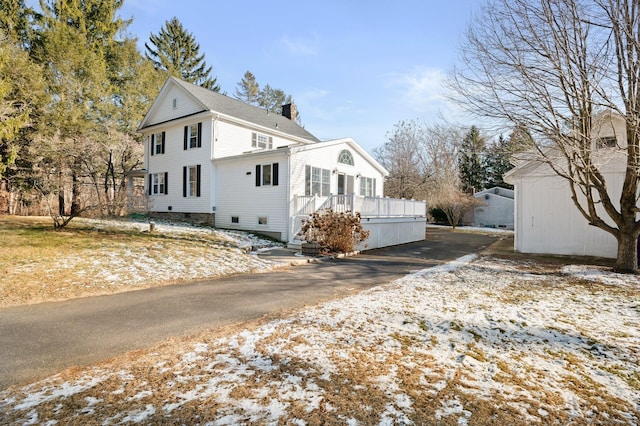 snow covered property featuring a deck