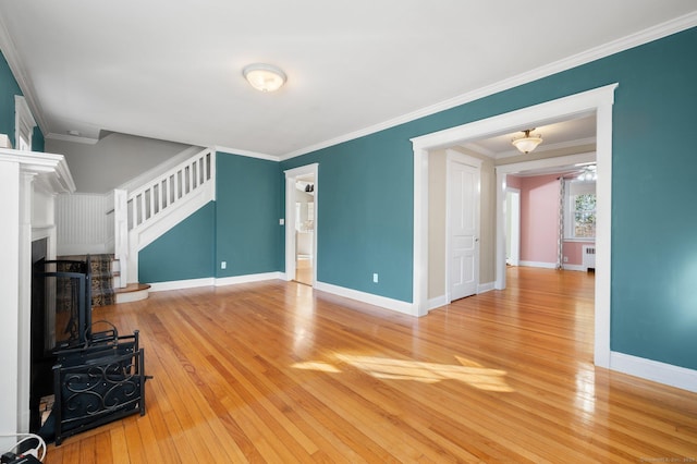 living room featuring radiator, light hardwood / wood-style floors, and ornamental molding