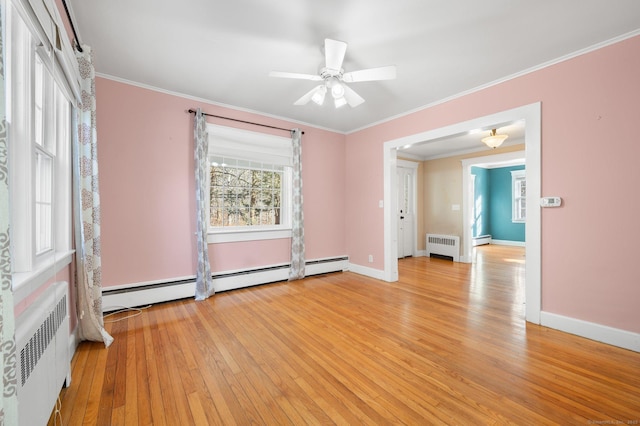 empty room with radiator heating unit, light hardwood / wood-style flooring, ceiling fan, and crown molding