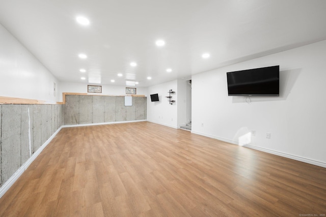 basement with light hardwood / wood-style flooring