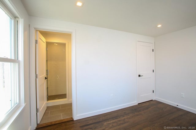 unfurnished room with dark wood-type flooring and a healthy amount of sunlight