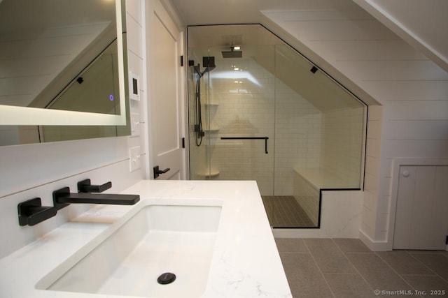 bathroom featuring vanity, tile patterned floors, and a shower with shower door