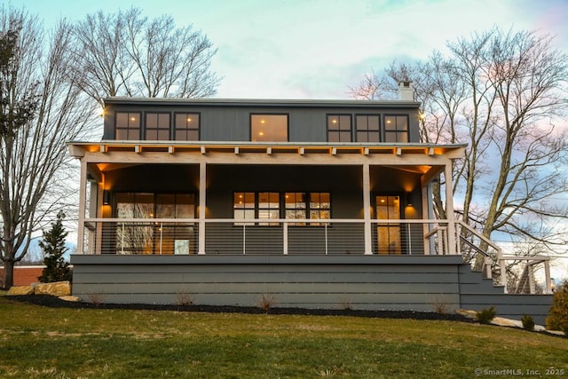 rear view of property with a lawn