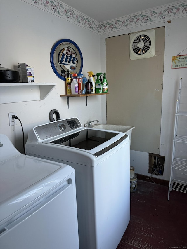 clothes washing area with sink and independent washer and dryer