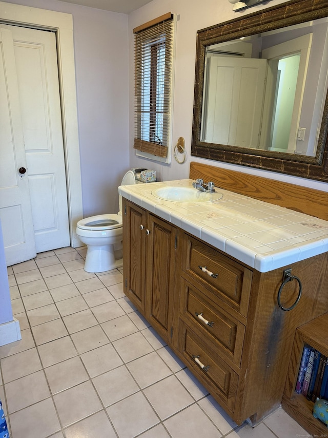 bathroom with tile patterned floors, vanity, and toilet