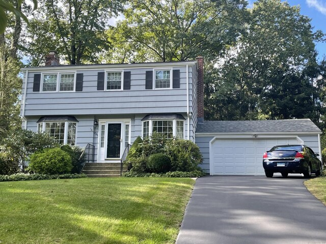 view of front of property featuring a garage and a front yard