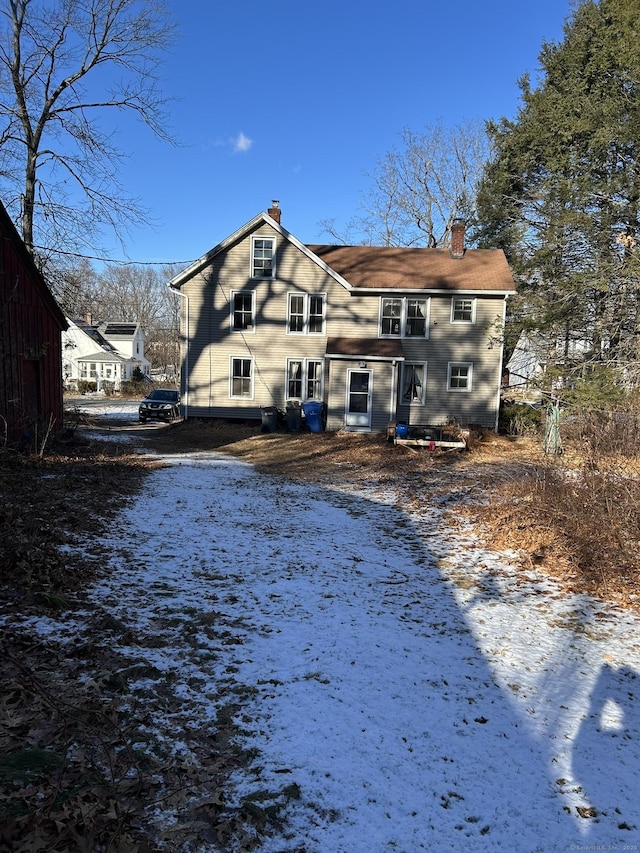 rear view of property with a chimney