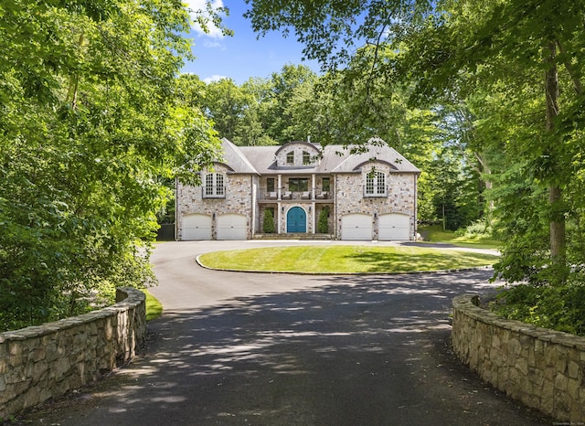 french provincial home featuring a garage and a front lawn