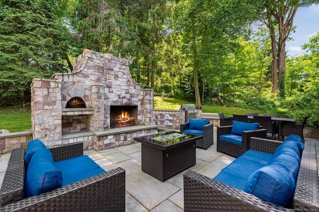 view of patio featuring a grill and an outdoor living space with a fireplace