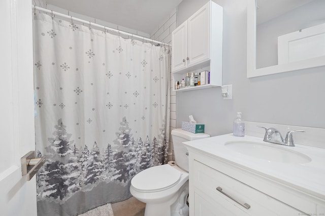 bathroom with vanity, curtained shower, and toilet