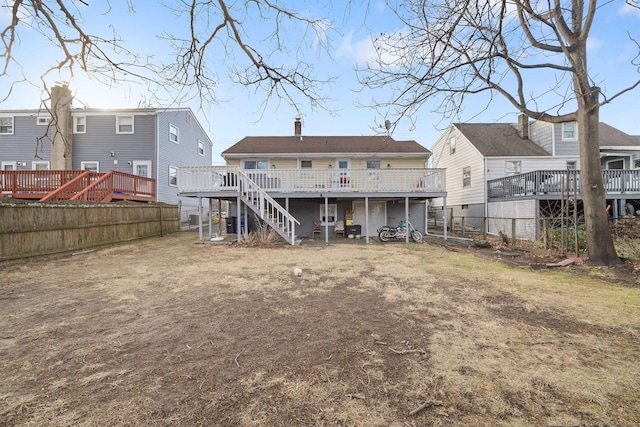 rear view of property featuring a wooden deck