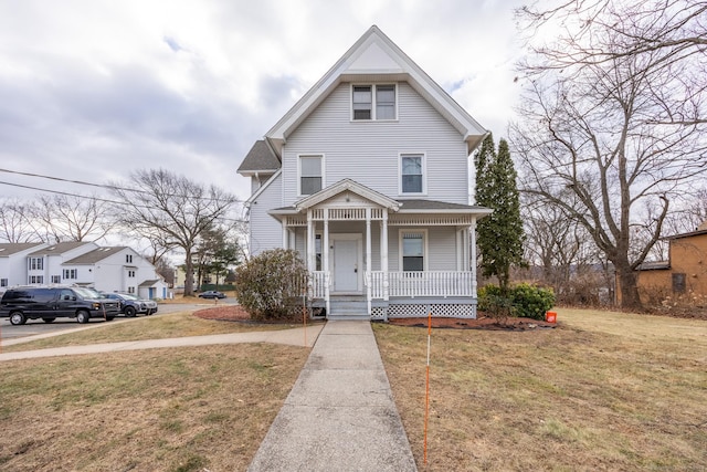 view of front of home featuring a front yard and a porch