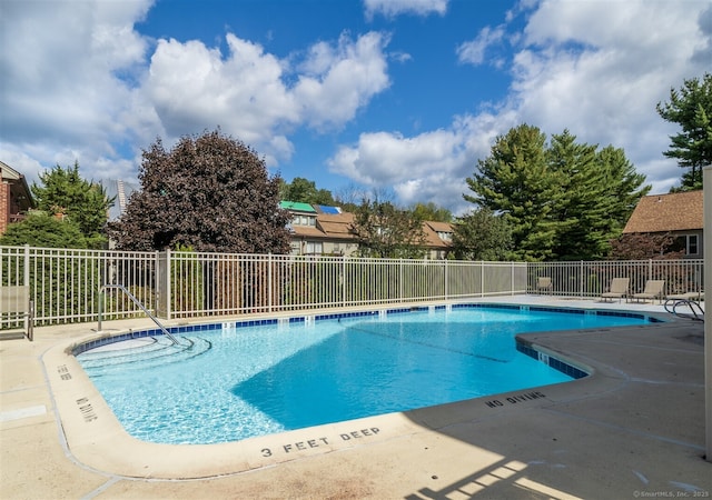 view of swimming pool with a patio area