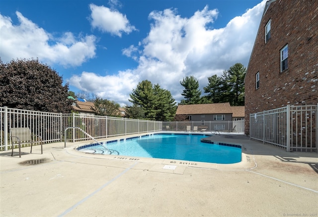 view of swimming pool with a patio area