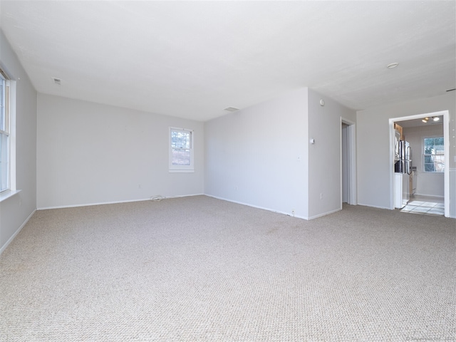 carpeted spare room with plenty of natural light