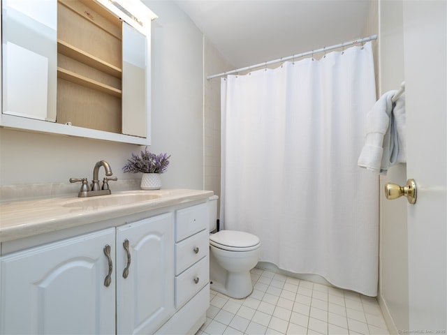 bathroom featuring tile patterned flooring, vanity, and toilet