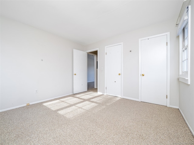 unfurnished bedroom with light colored carpet