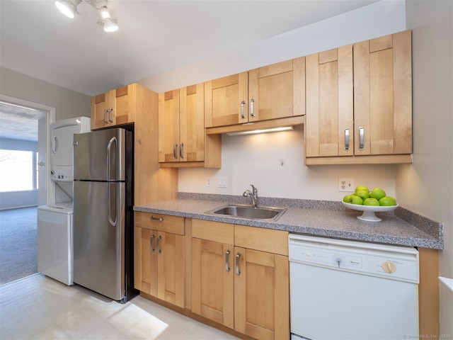 kitchen with dishwasher, sink, stainless steel fridge, light brown cabinetry, and light colored carpet