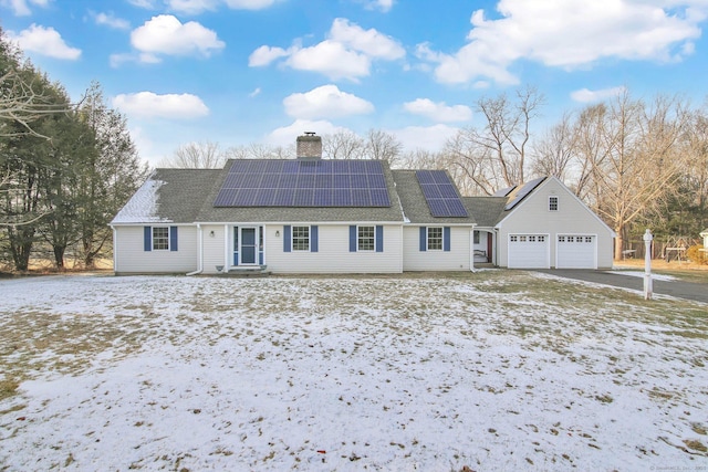 view of front of property featuring a garage and solar panels